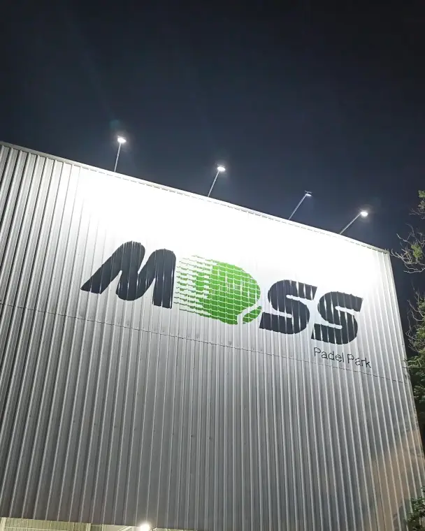 Moss sign on the building at night